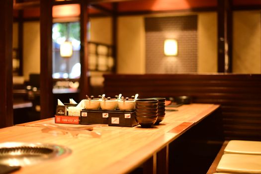 Warm and inviting restaurant interior with wooden tables and soft lighting, perfect ambience for dining.